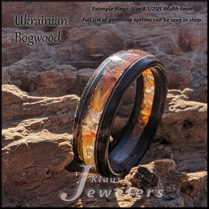 May include: A close-up of a ring made from Ukrainian bogwood with a clear resin inlay. The ring is 6mm wide and has a black metal band. The text "Example Rings: Size 8 1/2US Width 6mm" and "Full list of gemstone options can be seen in shop." is visible in the image.