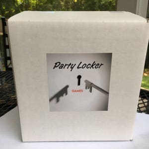 May include: White cardboard box with a sticker that says "Party Locker" and has a keyhole with a key in it. The keyhole says "GAMES" under it.
