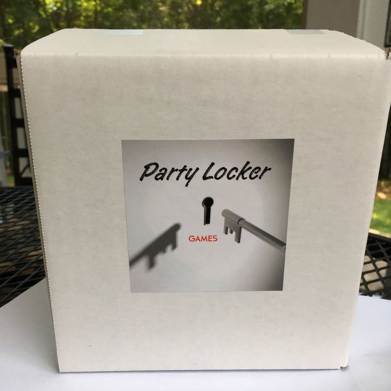 May include: White cardboard box with a sticker that says "Party Locker" and has a keyhole with a key in it. The keyhole says "GAMES" under it.