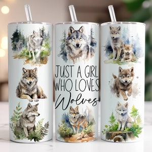 May include: White insulated tumbler featuring watercolor illustrations of wolves in various poses. The tumbler has a clear straw and the text "JUST A GIRL WHO LOVES Wolves". The design includes forest and nature elements.