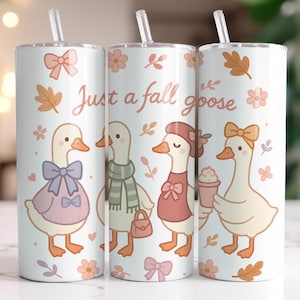 May include: Three white insulated tumblers with straws, featuring cartoon geese in fall attire. The text "Just a fall goose" is displayed. The design includes fall leaves, flowers, and bows in shades of orange, pink, and purple.