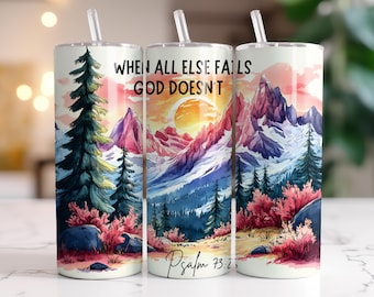 May include: A white tumbler with a colorful mountain scene and the text "When all else fails God doesn't" and "Psalm 73:26".