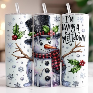May include: Three stainless steel tumblers with a white background and holiday designs. The tumbler on the left features a snowman with a red and black scarf and holly. The tumbler in the middle features a snowman with a red and black scarf and holly. The tumbler on the right features the text "I'm having a meltdown".