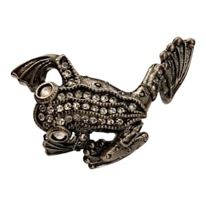 May include: A brooch shaped like a frog, crafted from dark, antiqued silver-tone metal. The frog's body is embellished with rows of clear, sparkling rhinestones, and it features two prominent, circular rhinestone eyes set into the head.
