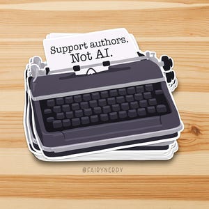 May include: A sticker featuring a vintage typewriter with the text "Support authors. Not AI." The typewriter is dark gray with a black keyboard and white paper. The sticker is on a wooden surface.
