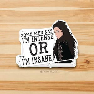 May include: A white sticker with a black and white illustration of a woman with long dark hair. The text on the sticker reads "Some men say I'm intense or I'm insane" with the words "or" in large bold letters. The sticker has the text "@fairynerdy" at the bottom.