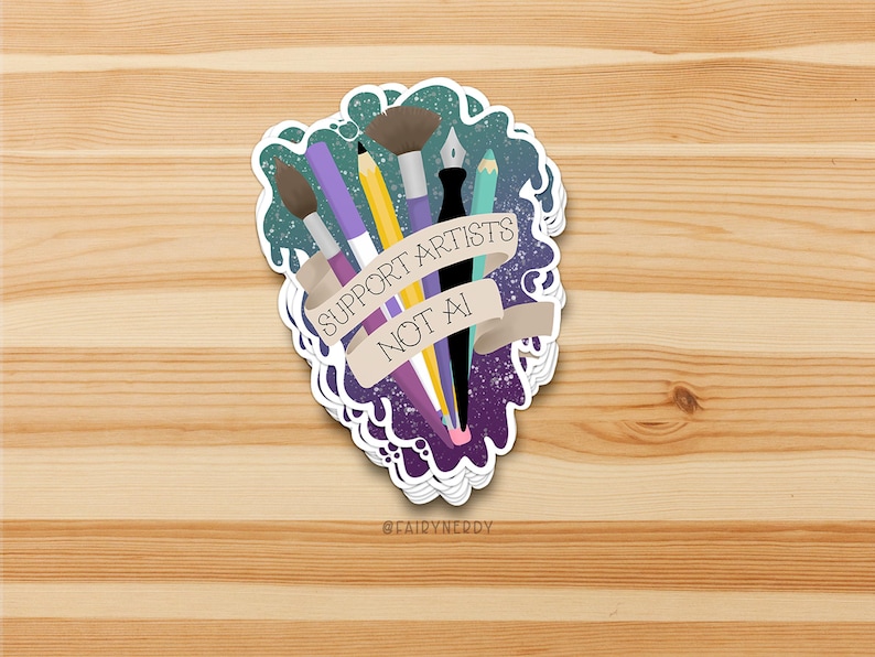 A vinyl sticker with a digital illustration of multiple art tools like paintbrushes, pencils, and markers with a banner that reads, "Support Artists, Not AI." The entire design is on a paint-like green and purple background.