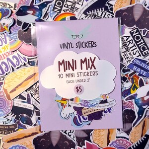 May include: A package of vinyl stickers with a light purple background. The package reads "VINYL STICKERS MINI MIX" with "10 MINI STICKERS EACH UNDER 2"" and a price of $5. The stickers feature various designs, including a unicorn and a whale.