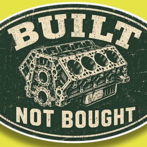 May include: Oval-shaped sign with a distressed design. The sign features a detailed illustration of an engine block in shades of green and beige. The words "BUILT" and "NOT BOUGHT" are prominently displayed in a vintage font.