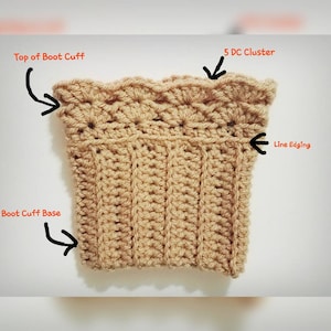 May include: A close-up of a beige crocheted boot cuff with a scalloped top edge. The cuff has a line edging and a 5 DC cluster detail. The top of the boot cuff and the boot cuff base are labelled.