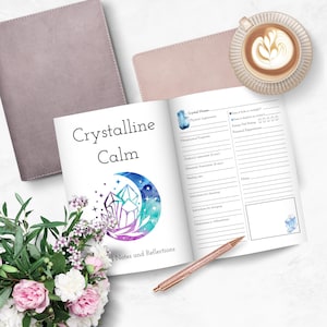 May include: A white journal with the title "Crystalline Calm" and a watercolor illustration of a crescent moon with crystals. The journal has a section for notes and reflections and a section for crystal information, including name, physical appearance, metaphysical properties, chakra, elemental association, handling, instructions for cleansing, instructions for charging, and meditations in alignment.