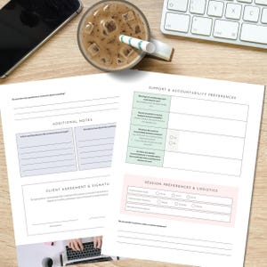 May include: A workspace scene featuring a smartphone, a glass of iced coffee with a straw, a keyboard, and two sheets of paper with forms and text. The papers include sections for notes, agreements, and preferences.