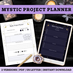 May include: A Mystic Project Planner set featuring a white paper sheet and a tablet screen displaying matching templates. Both include celestial motifs, moon phases, and tarot card illustrations. A gold pen and a purple geode are placed nearby.
