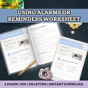May include: A worksheet titled "USING ALARMS OR REMINDERS WORKSHEET" with the text "Using Alarms or Reminders" on the pages. The worksheet includes sections for setting reminders and finding the best reminder method. A gold pen and a decorative stone are also visible.