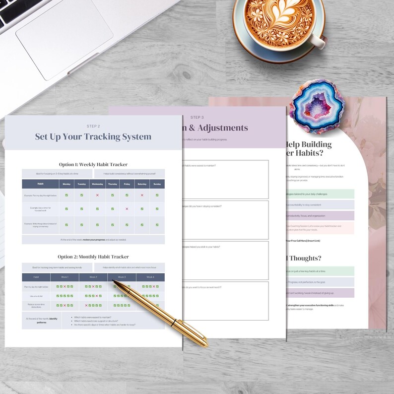 May include: A top-down view of a workspace with a laptop, coffee cup, and habit tracker printables. The printables include a weekly and monthly habit tracker, and a page titled "Help Building Better Habits?" A gold pen rests on the pages.