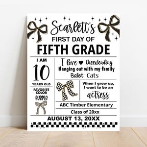 May include: A white sign with black text and gold bow accents. The sign reads "Scarlett's First Day of Fifth Grade." It includes details like age, favorite color, interests, and future aspirations. The date is August 13, 20XX.