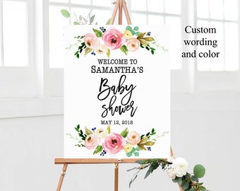 Op de afbeelding: Een wit bord met bloemenversiering en de tekst "Welkom op Samantha's babyshower op 12 mei 2018".