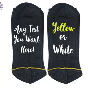 May include: Pair of black ankle socks with gold trim. One sock has the text "Any Text You Want Here!" in white. The other sock has "Yellow or White" in yellow and white.