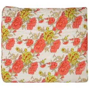 May include: A white quilt with a floral pattern featuring pink roses and yellow flowers on a white background.