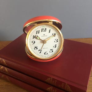 Vintage Travel Alarm Clock by Junghans | Mechanical Desk Clock | Table Clock with Case | Red Brass Wind-Up Clock | Made in Germany, 1950s