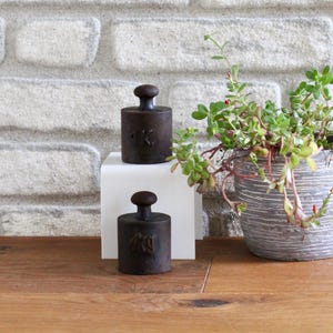 Antique Iron Weights | Two 1 kg Weights for Kitchen Scales | Vintage Black Cast Iron Weights with Patina and Rust | Austria, 1910 to 1920