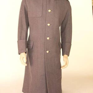 May include: A long, dark grey wool coat with a stand-up collar and five gold buttons down the front.