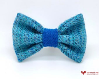 May include: A turquoise and blue tweed bow tie. The bow tie has a textured appearance with a solid blue center band. The bow tie is designed for a dog. The handmade.dog logo is in the bottom right corner.
