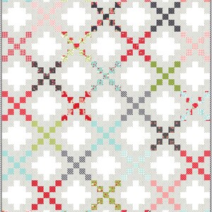 May include: A colourful quilt featuring a repeating pattern of diagonal crosses. The crosses are composed of small squares in various colours, including red, pink, green, and blue, set against a white background. The quilt has a dotted border.