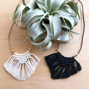 Handmade macramé necklace on leather cord.