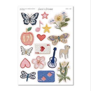 May include: A sheet of decorative embroidered patches featuring various designs, including butterflies, stars, a musical note, a heart, an apple, a guitar, a lamb, and flowers. The patches are in various colors, including blue, pink, yellow, and green. The text "Sadie's Stickers" is at the top.