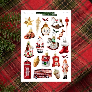 May include: A sheet of vintage bauble stickers featuring festive holiday designs. Includes a gold star, clock, Santa, rocking horse, red bus, and other ornaments. The text "THE HOLIDAY EDIT" and "SADIE'S STICKERS" are visible.