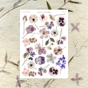 May include: A sticker sheet featuring an assortment of pressed flowers in various shapes and colors, including white, pink, purple, and blue. The sheet is labeled "Sadie's Stickers" and "Pressed Flowers."