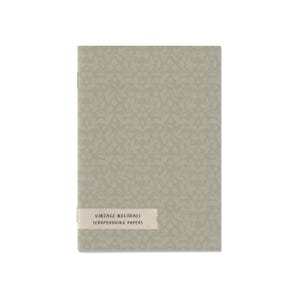 Może przedstawiać: Prostokątny stos papierów do scrapbookingu z stonowanym zielonym wzorem kwiatowym. Papiery mają jasnobeżową etykietę z napisem "VINTAGE NEUTRALS SCRAPBOOKING PAPERS". Na białym tle.