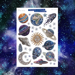 May include: A sheet of outer space themed stickers featuring planets, stars, a sun with a face, a crescent moon, a comet, and an alien. The stickers have glitter and metallic accents. The text "TRINKETS & TIDBITS" and "BADIE'S STICKERS" is printed on the sheet.