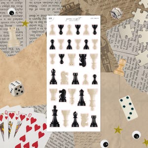 May include: A sheet of chess piece stickers in black and cream colors. The stickers are arranged in rows and columns, with various chess pieces visible. The words "game night" are printed at the top. Other game pieces like dice and playing cards are also visible.