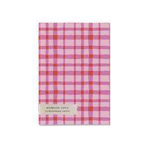 May include: A rectangular scrapbook paper pad with a pink and red plaid pattern. The text "WHIMSICAL GIRLIE SCRAPBOOKING PAPERS" is printed on a light beige label at the bottom of the pad.