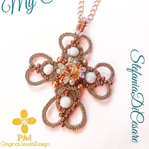 Può includere: Una collana con catena dorata con un ciondolo a forma di croce in perle marroni e bianche. La croce è realizzata con piccole perle e presenta un design delicato e intricato.