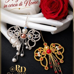 May include: Two handcrafted angel ornaments featuring intricate beadwork. One is silver with a peach-colored center bead and white pearls, the other is gold with a red center bead and red crystals. Text reads Angelo in cerca di Nome and P&D Stefania DiCesare.