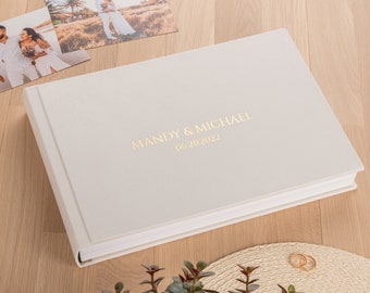 May include: A white photo album with the text "Mandy & Michael 06.20.2022" printed in gold on the cover.