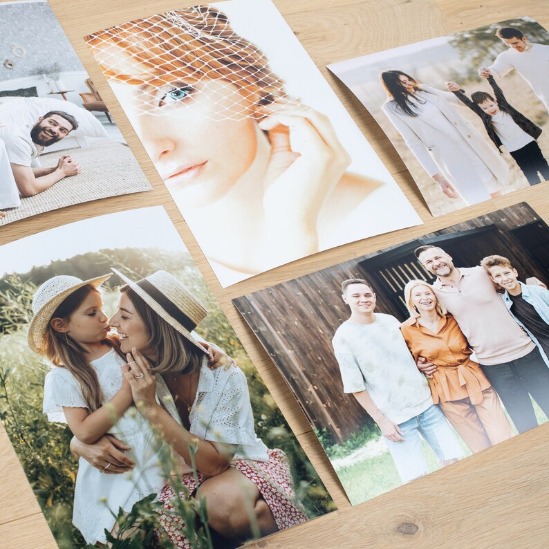 May include: Five different photographs of people in various settings. The first photo shows a woman with a veil over her face. The second photo shows a couple embracing in a field. The third photo shows a family of four standing in front of a wooden building. The fourth photo shows a woman with a veil over her face. The fifth photo shows a family of four standing in front of a wooden building.
