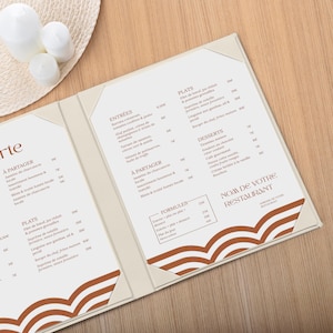 May include: A restaurant menu folder with a cream-colored cover featuring a brown wave pattern at the bottom. The interior displays a printed list of food items under headings like Entrées, Plats, and Desserts, with the text Nom de votre restaurant.