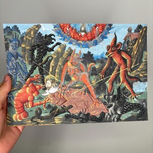 May include: A vintage print depicting a scene with several fantastical creatures in shades of red, black, blue, and orange. The artwork features a central figure surrounded by various monsters and a celestial scene above. The print is held by a hand.