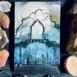 May include: A "Shadow Journey Tarot" guidebook with a blue and gray cover featuring an archway design. The book includes the text "A Guidebook" and the names J. Edward Neill & Heather R. Hester.