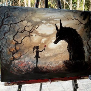 May include: An original painting on canvas depicting a surreal scene. A silhouetted girl offers a red flower to a large, black wolf-like creature. The background features a dark, moody forest with bare trees and a cloudy sky.