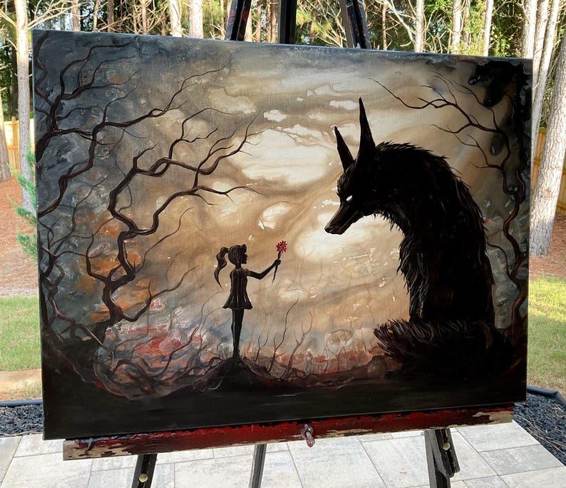 May include: An original painting on canvas depicting a surreal scene. A silhouetted girl offers a red flower to a large, black wolf-like creature. The background features a dark, moody forest with bare trees and a cloudy sky.