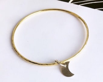 Hammered brass bangle with silver moon charm