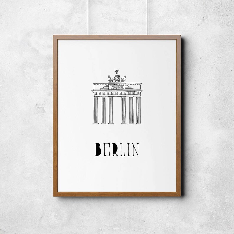 May include: A black and white line drawing of the Brandenburg Gate in Berlin, Germany. The text "BERLIN" is below the gate.