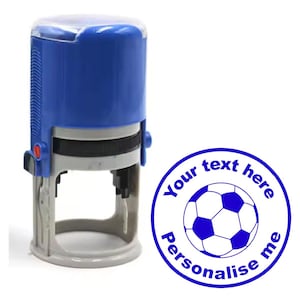 May include: Blue self-inking stamp with a white plastic base. The stamp features a blue football graphic and the text "Your text here personalise me".