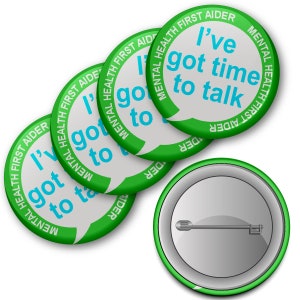 May include: Four green and white button badges with the text "Mental Health First Aider" and a speech bubble that says "I've got time to talk".