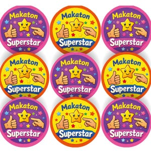 May include: Nine circular stickers displaying the words "Makaton" and "Superstar". Each sticker features a yellow star, a thumbs-up, and a pointing hand. The stickers have pink, purple, and yellow backgrounds with star accents.